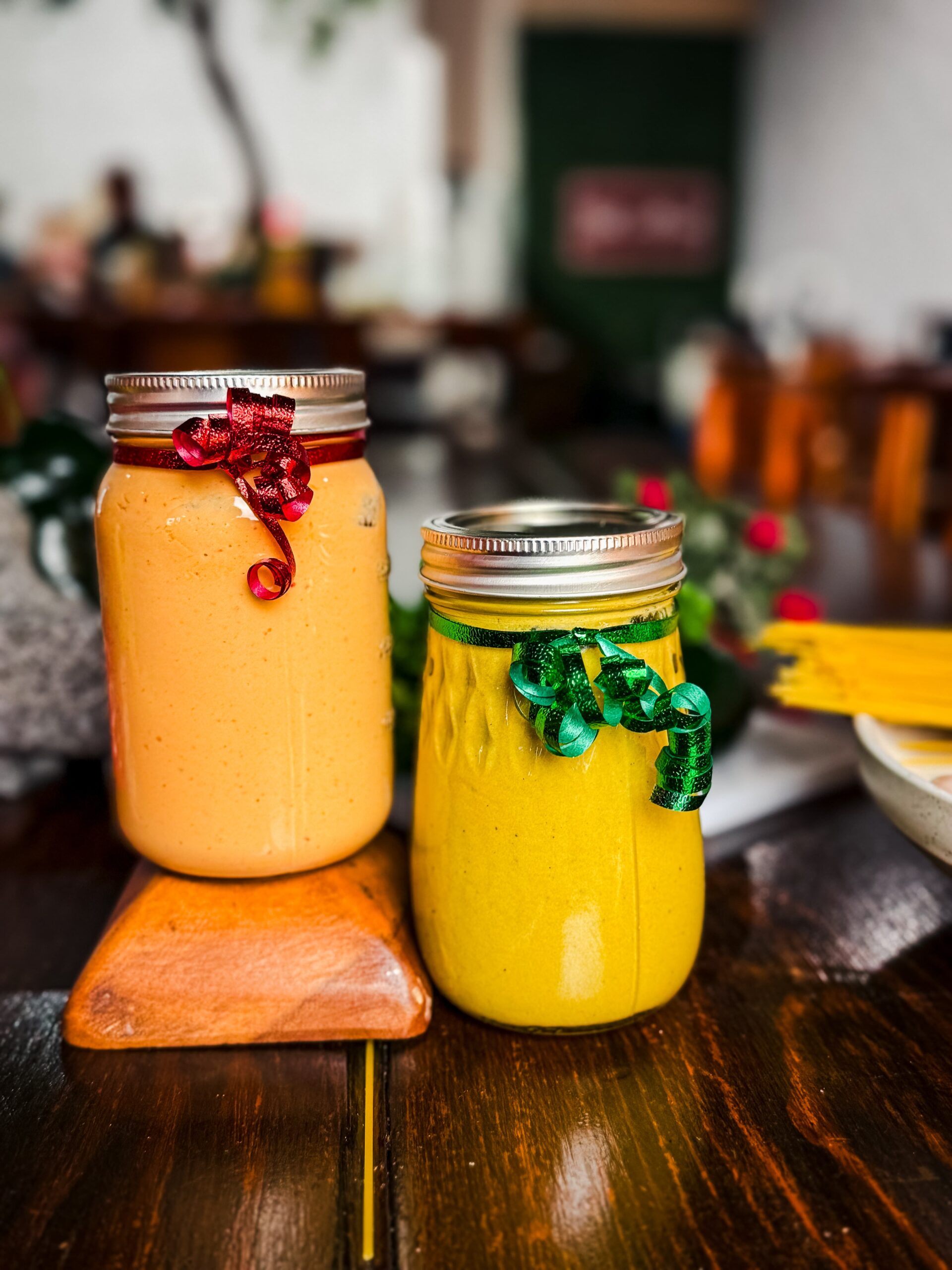 Close up of Todo Natural chipotle cream and poblano cream mason jars with festive ribbon bows - Christmas holiday catering sauces for easy meals in Brownsville Texas